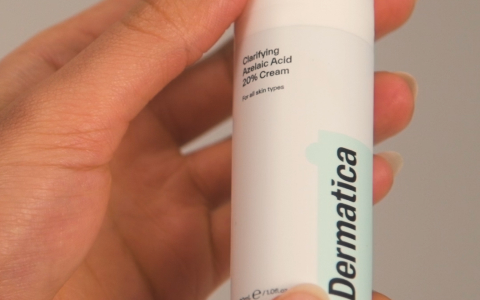 Smiling Woman With Dermatica Bottle