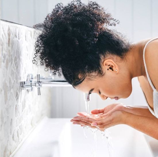 Woman washing her face