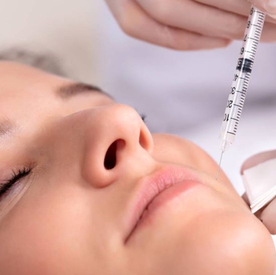 Woman applying botox