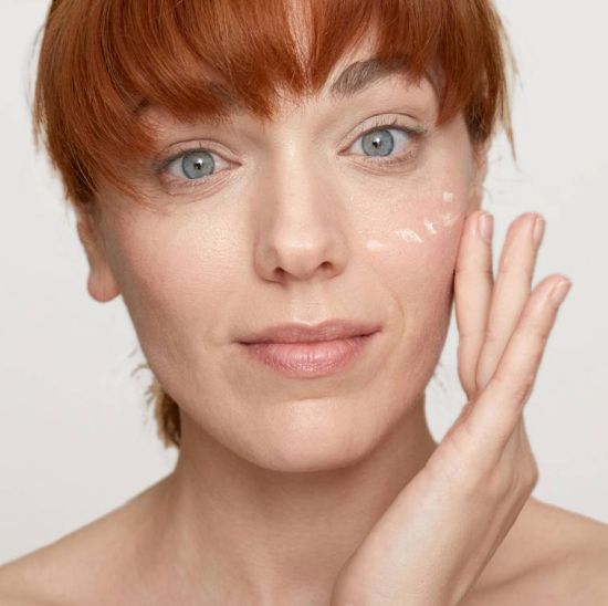 Woman applying tretinoin