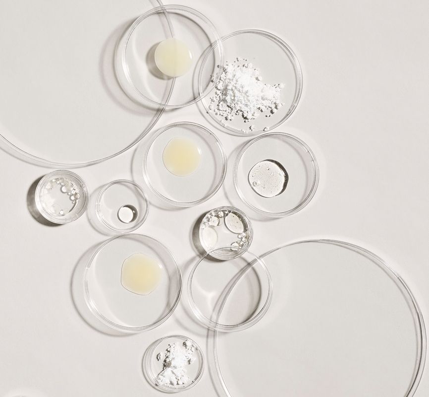 Ingredients for Advanced Dark Spot Corrector Serum, including a powder, a cream, and a liquid