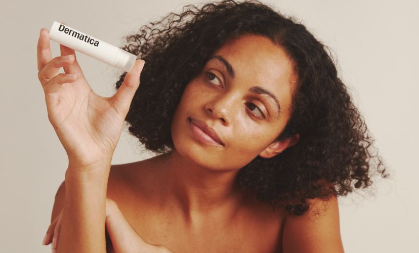 Dermatica - Smiling woman holding Dermatica bottle in the hand