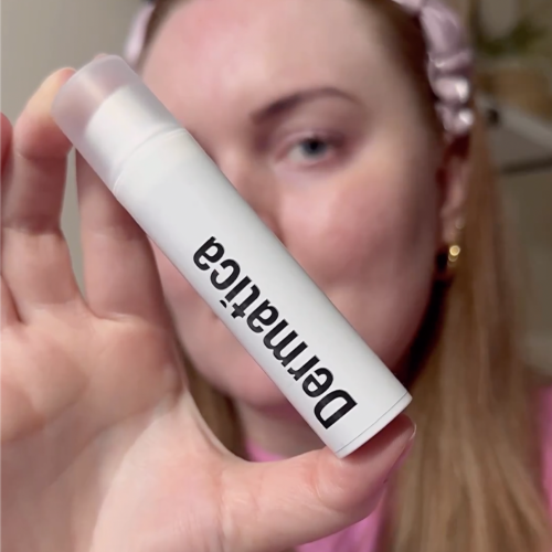 Happy customer holding Dermatica treatment bottle